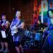 Four musicians playing instruments in a band