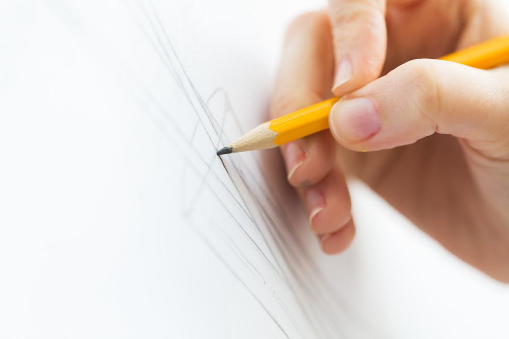 close-up of artist drawng a picture with pencil