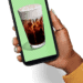 hand holding phone with picture of beverage on it