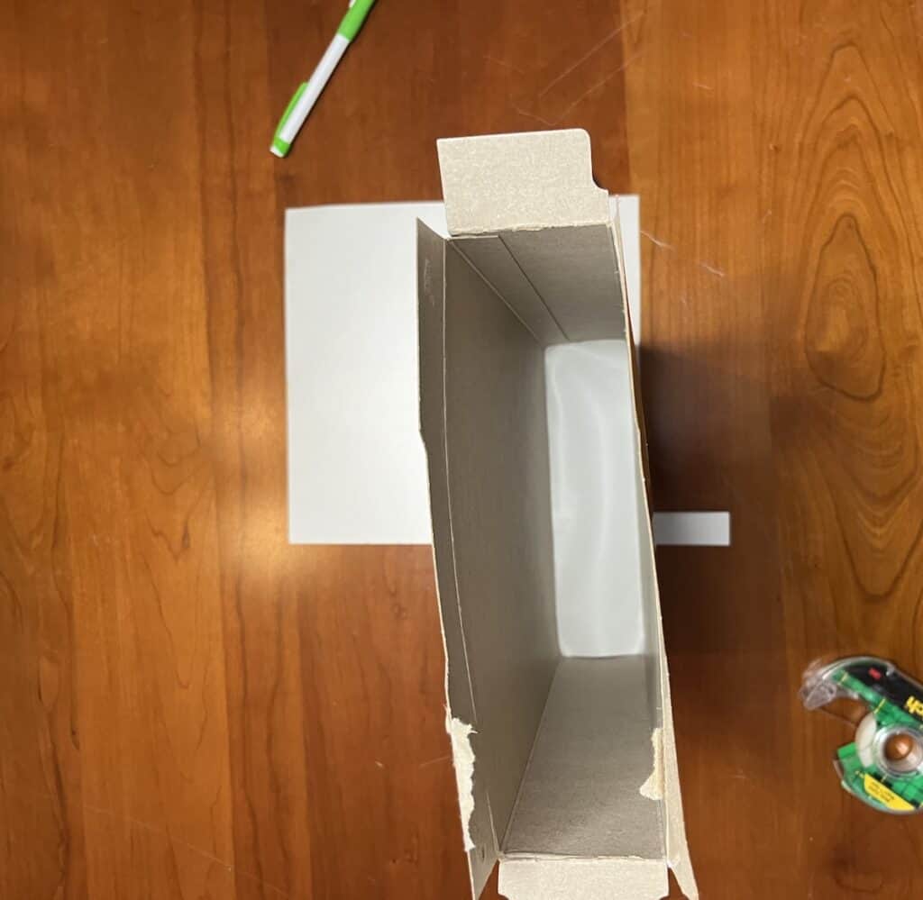White paper on bottom of cereal box pinhole viewer for eclipse