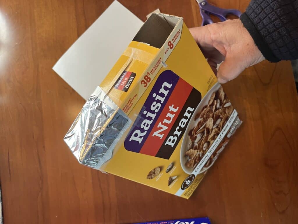 Cereal box with foil taped to opening