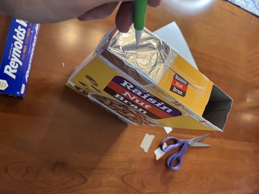putting pinhole in pinhole viewer for solar eclipse