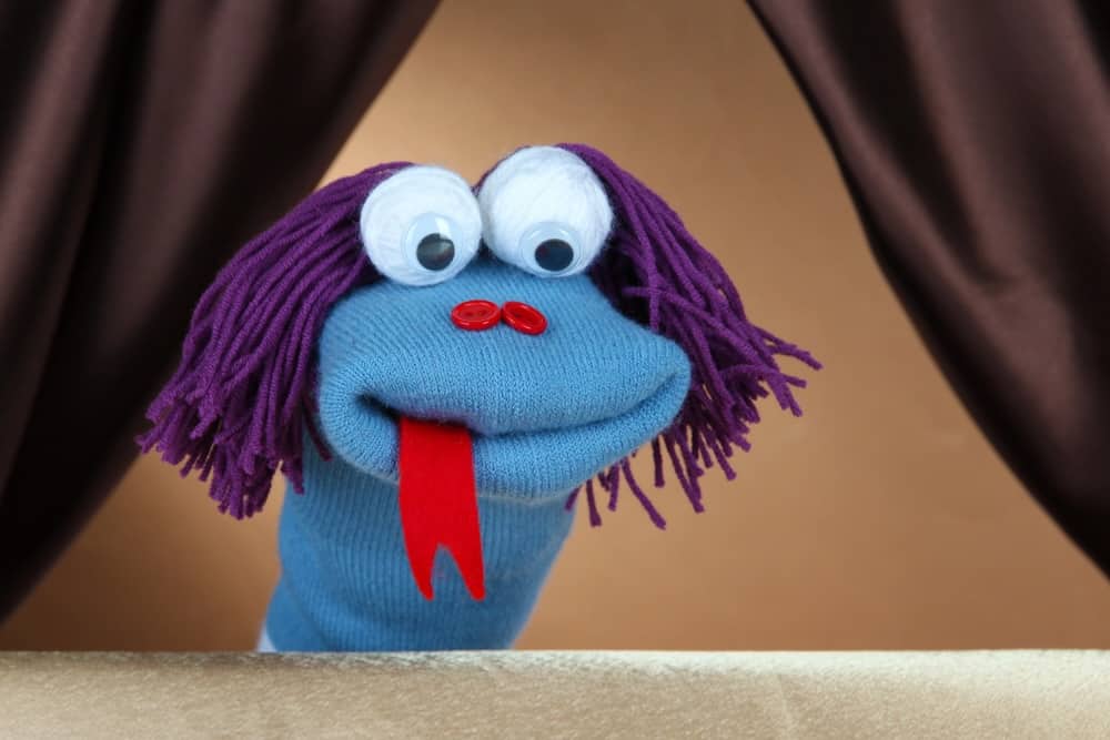blue puppet on brown background