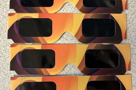 Four pairs of paper solar eclipse glasses for the April 8, 2024 solar eclipse