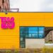 Yellow exterior of Taco Boy with pink letters