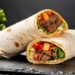 two burritos on a table
