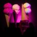 Ice cream cones on black background with pink lighting