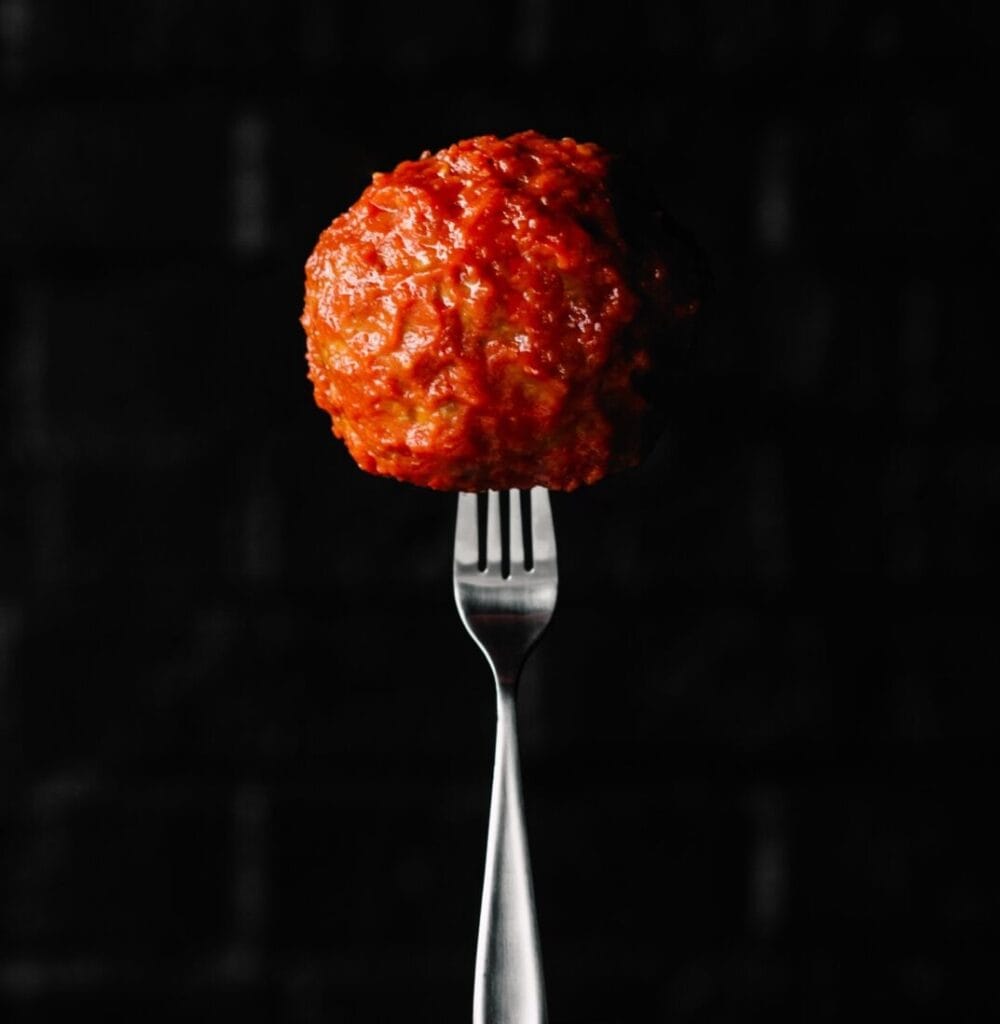 Meatball on a fork for national meatball day at piada