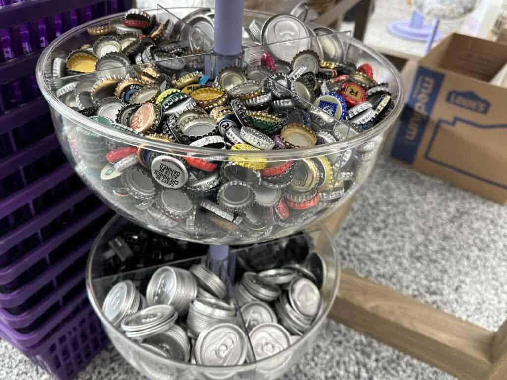 Containers of bottle caps and can lids at Upcycle Arts in Charlotte