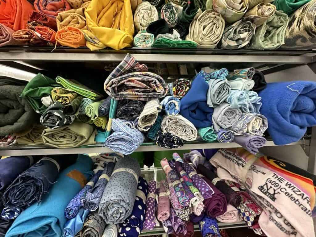 Variety of fabrics on shelf at Upcycle Arts in Charlotte