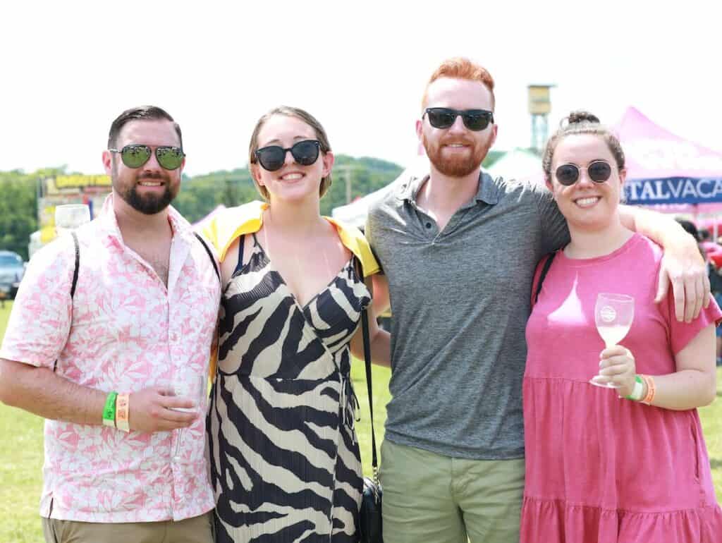 4 people enjoying glasses of wine outdoors