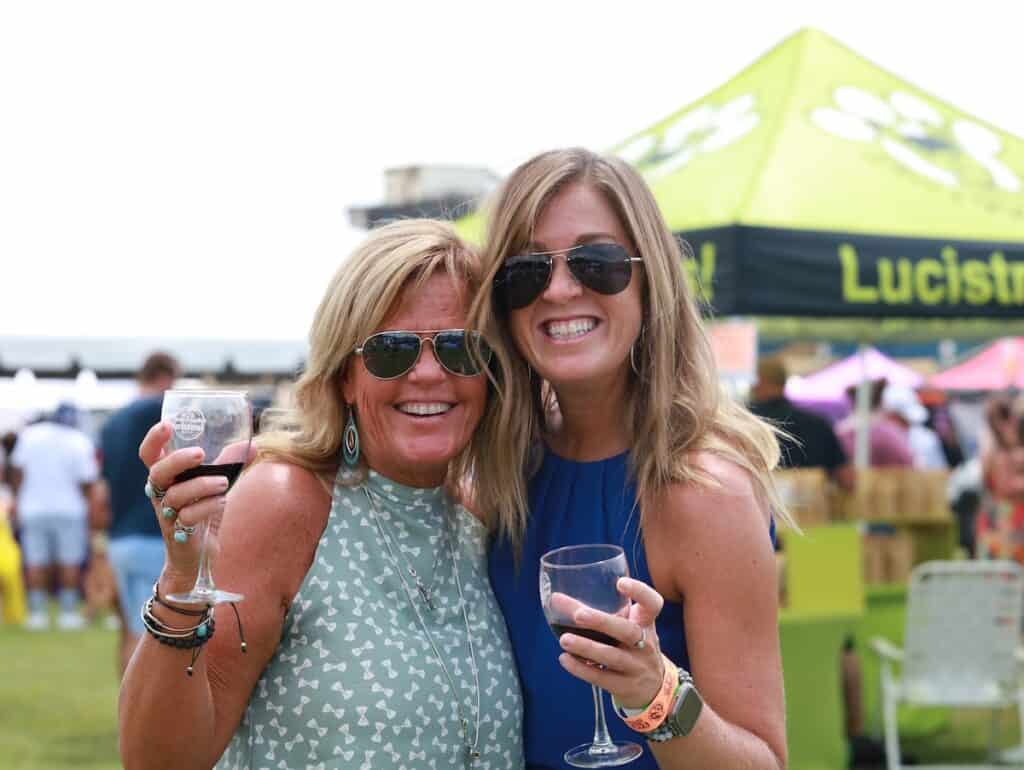2 women enjoying wine outdoors