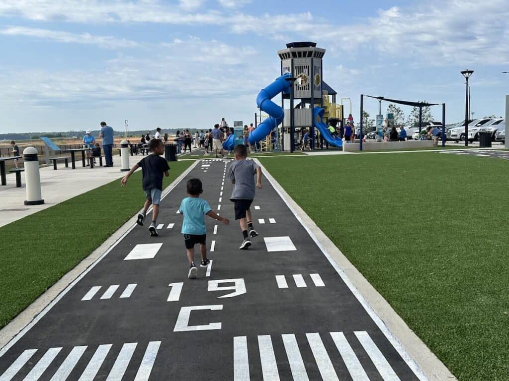 Kids racing on runway of CLT Airport Overlook
