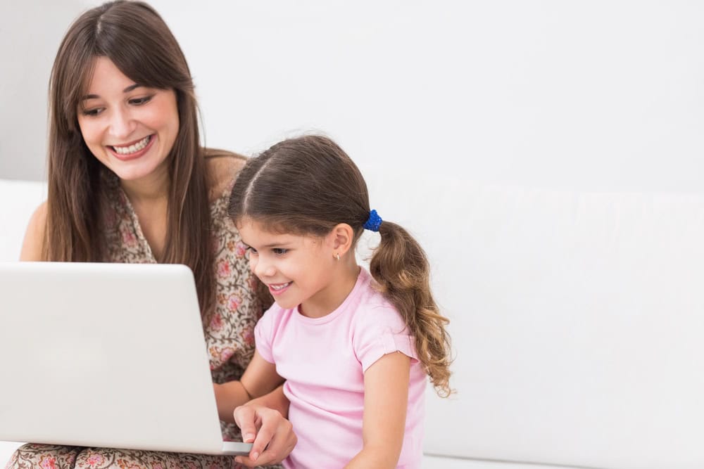 mother and daughter using laptop