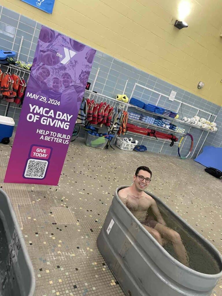 person in icy water in metal tub at Johnston YMCA