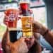 hands holding four beer glasses