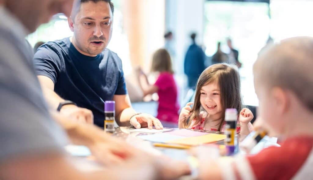 Family at a table making art