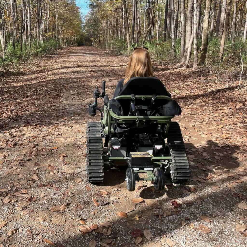 Person riding all terrain wheelchair on a trail