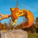 man smashing pumpkin with axe