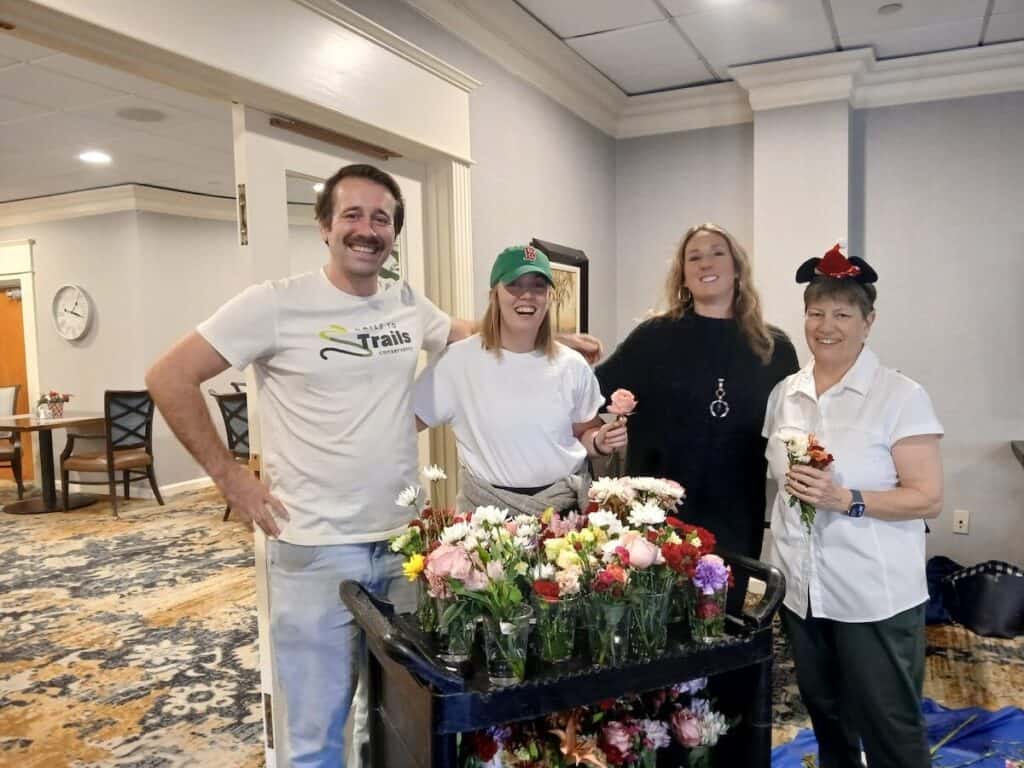 people with cart of flower arrangements