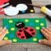 child making ladybug craft