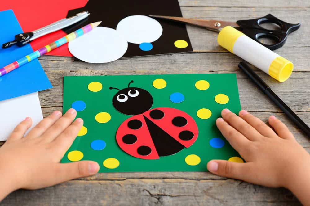 child making ladybug craft