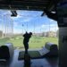 A man is playing golf on a golf simulator