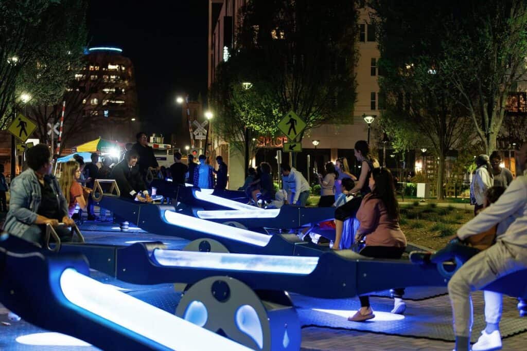 Adults and kids on light-up see saws