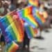 People holding rainbow flags in a parade