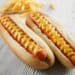 two hot dogs on buns with mustard
