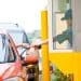 driver receiving bag of food at drive-thru