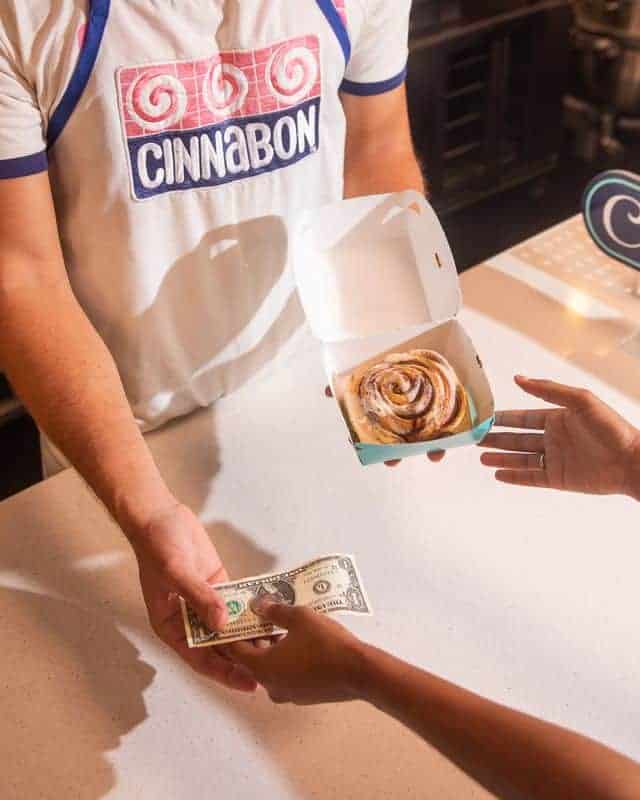 Person buying Cinnabon