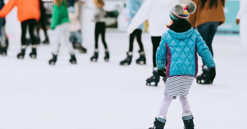 Child ice skating outside