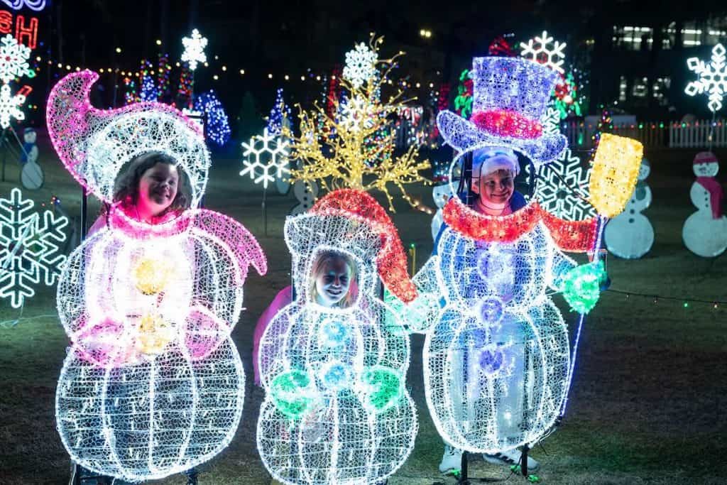 Children posting with light-up snowmen