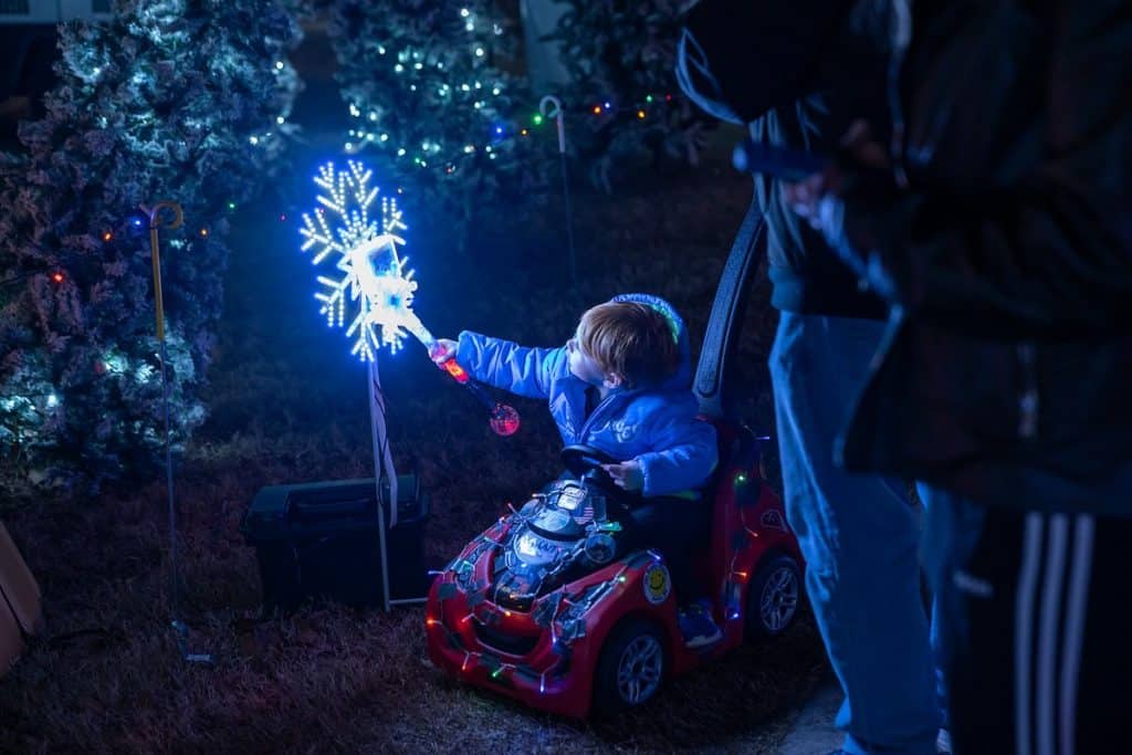Child in wagon with wand