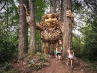 children looking at giant troll sculpture in Seattle