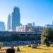 people running on path in cemetery with Charlotte city skyline in background