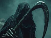 Sinister grim reaper is holding a scythe in a foggy landscape