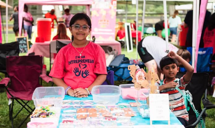 kids selling objects at market