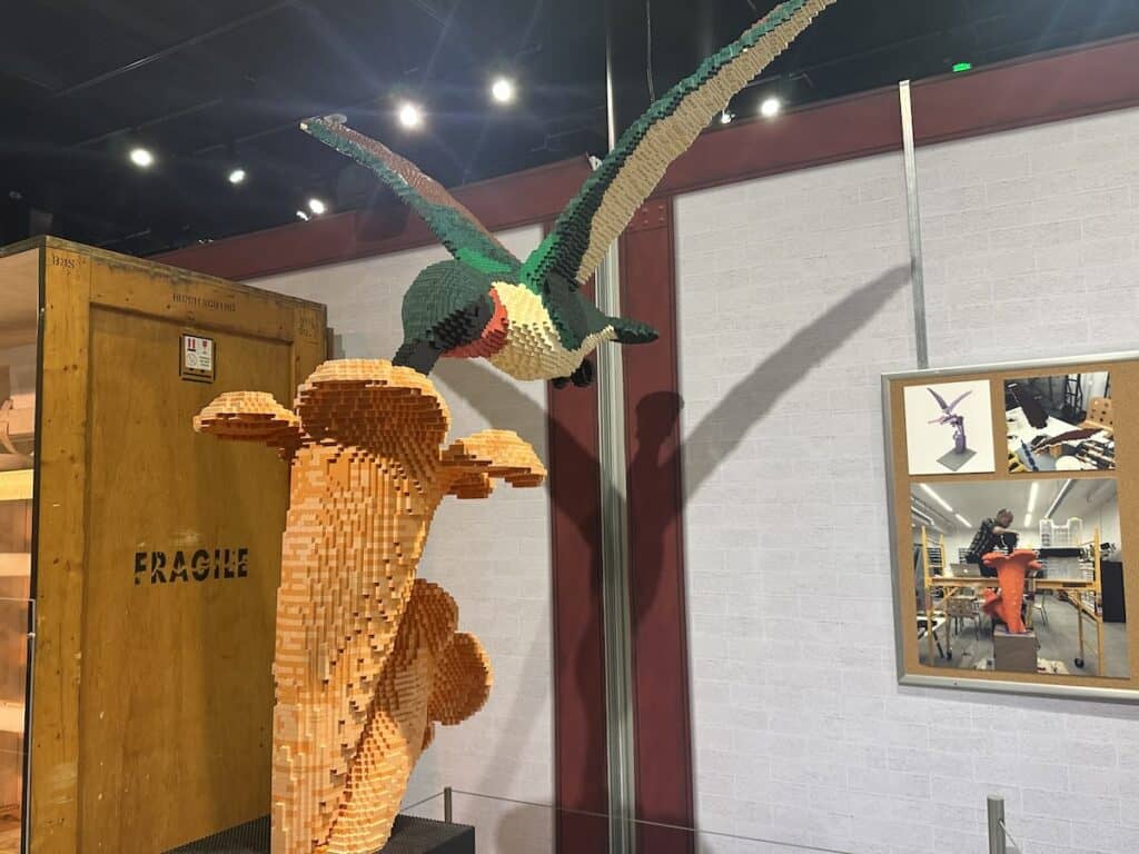 Sculpture of hummingbird drinking nectar, made from LEGOs