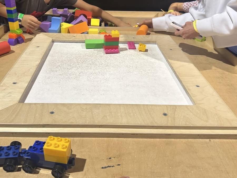 Children building with LEGOs at table at Discovery Place Science in Charlotte