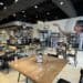 Interior of Percantile & Creamery, showing 20s-themed mural tables and chairs, merchandise and counter