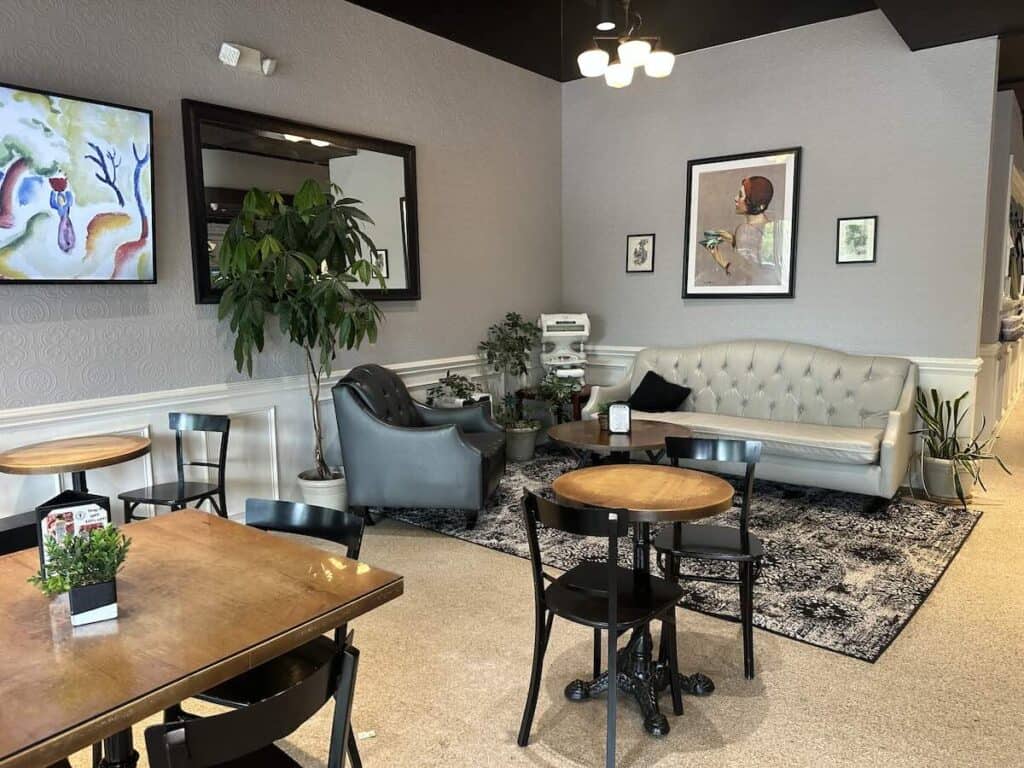 Interior of Percantile & Creamery, with a couch, chair and tables
