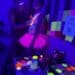 Artist painting woman under black light