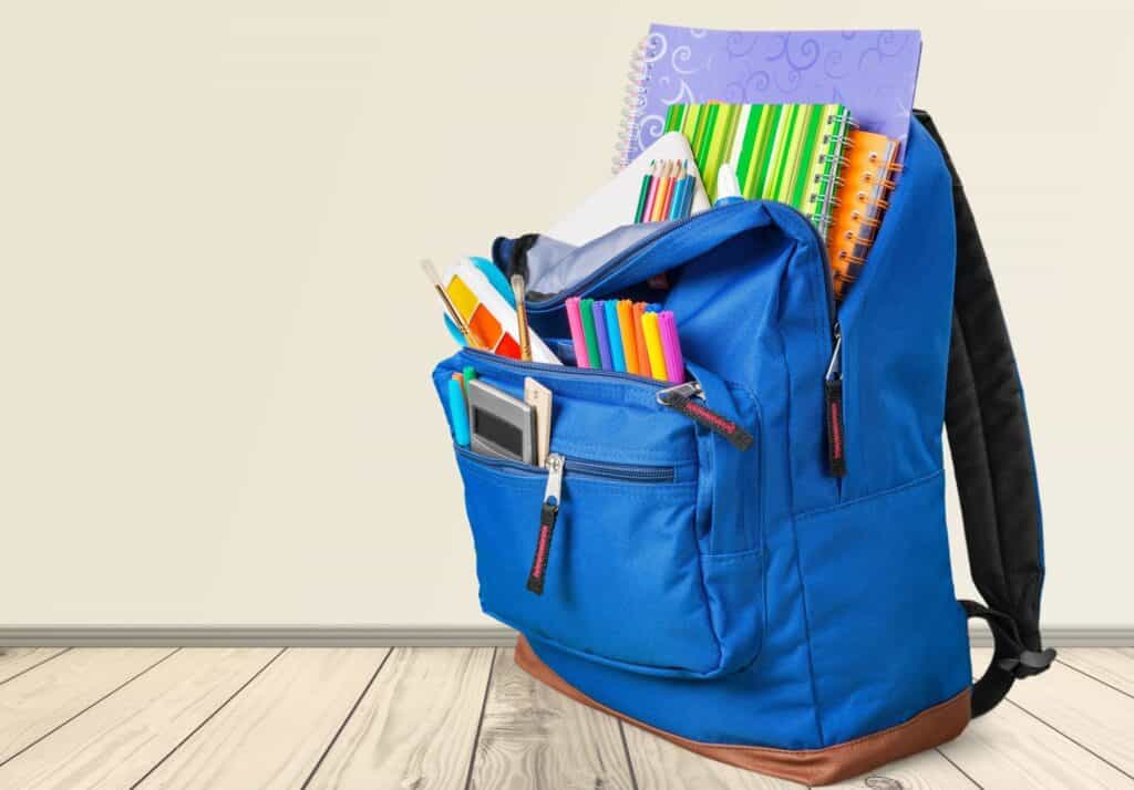 Blue backpack filled with school supplies