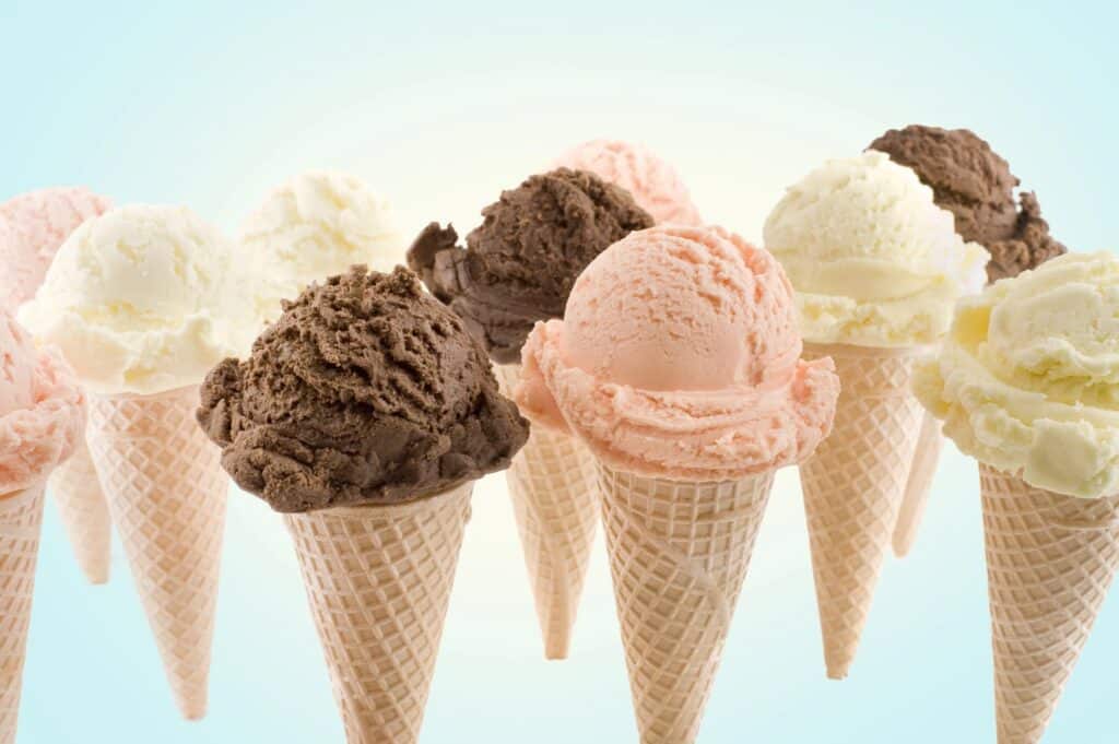 Multiple cones of ice cream against a blank background