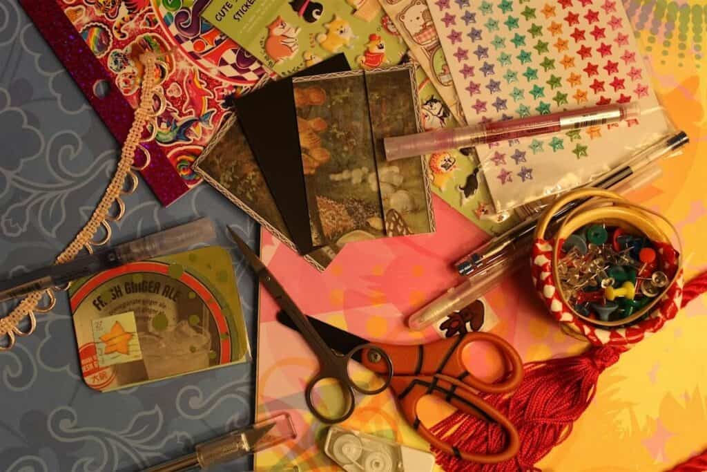 artist trading cards and crafting supplies photographed from above on a flat surface