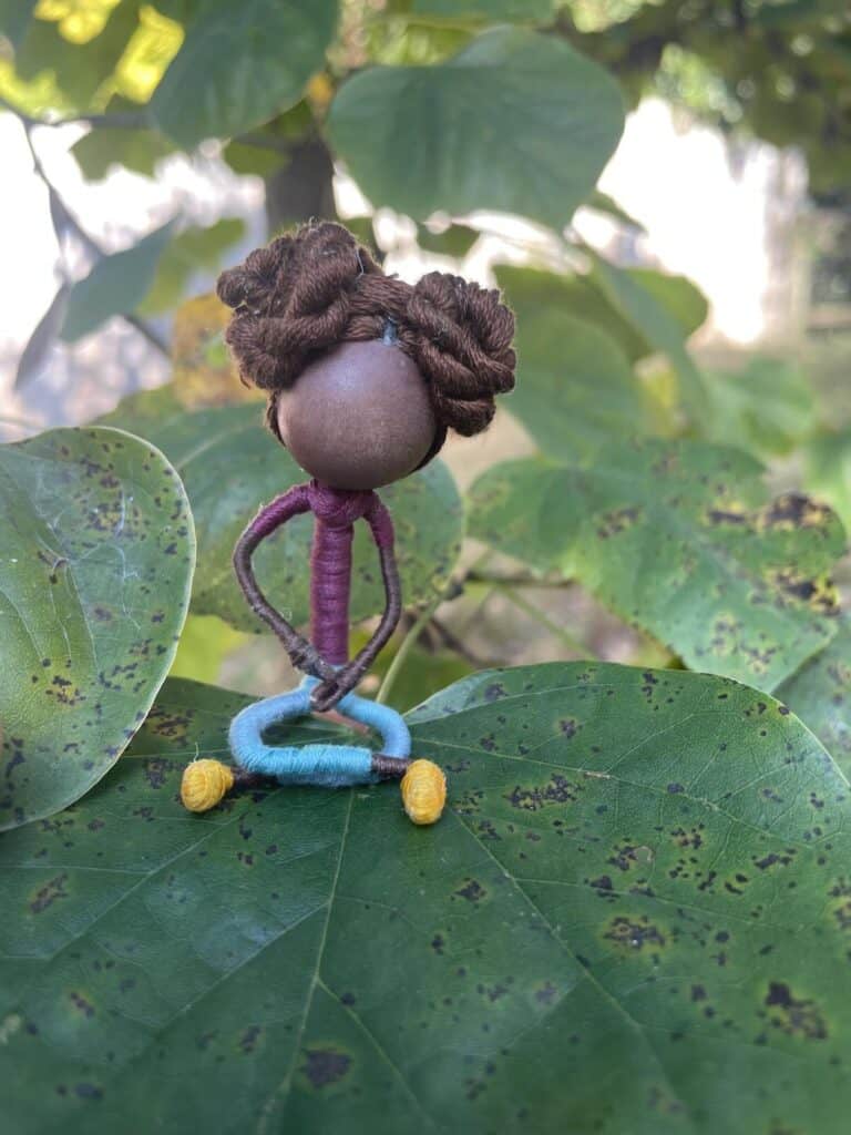 tiny doll on leaf